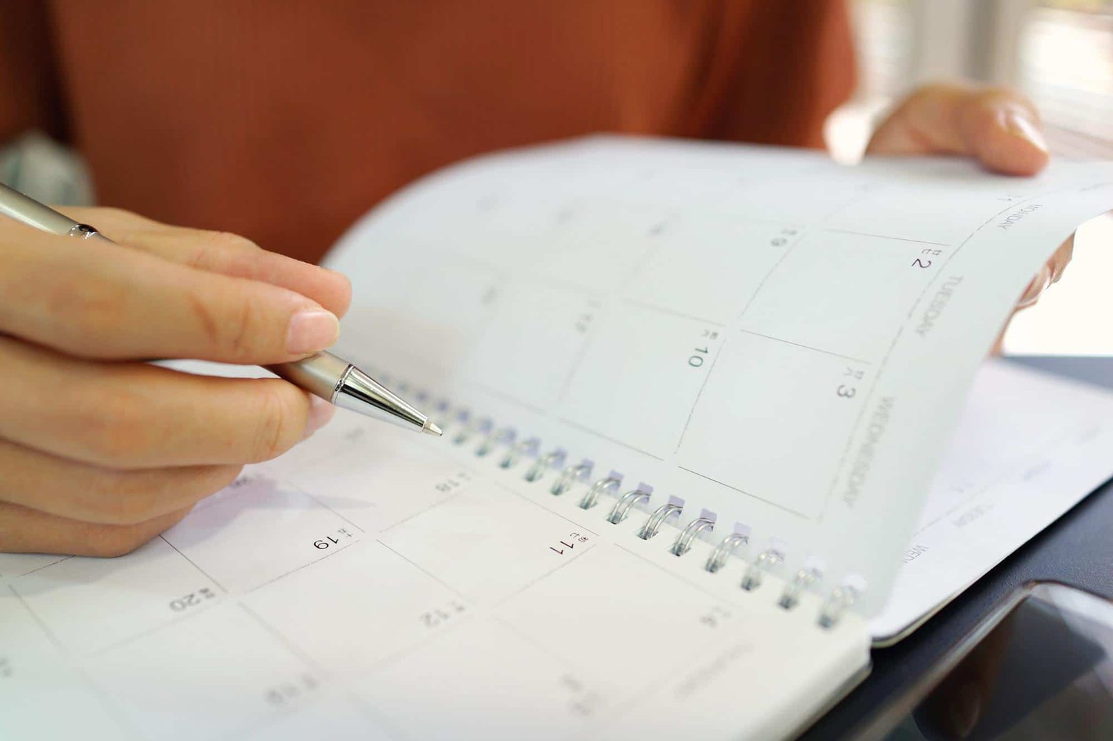 Female planning schedule and appointment on calendar planner