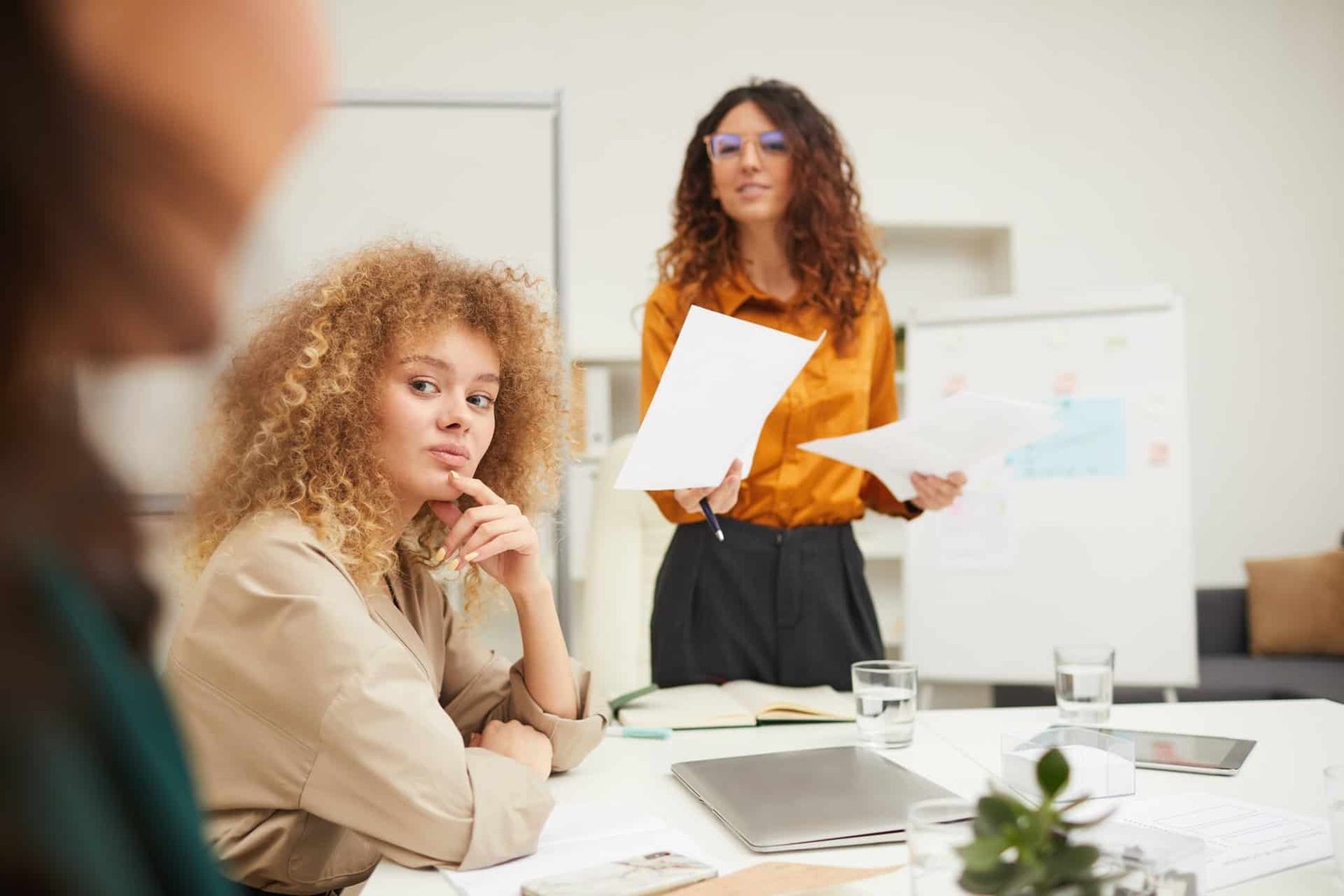 Businesswomen Interacting With Their Colleague